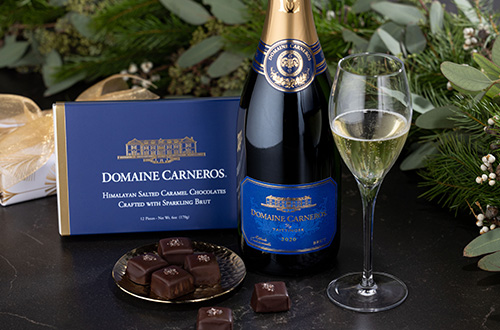 Box of Domaine Carneros Chocolates with bottle and glass of Estate Brut